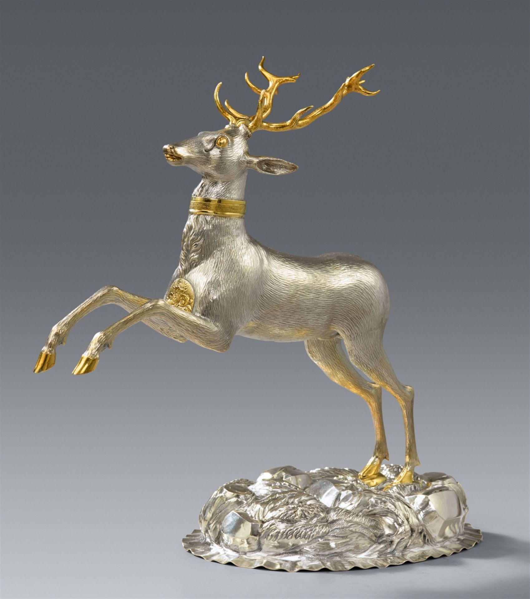 A parcel gilt silver drinking vessel in the form of a stag