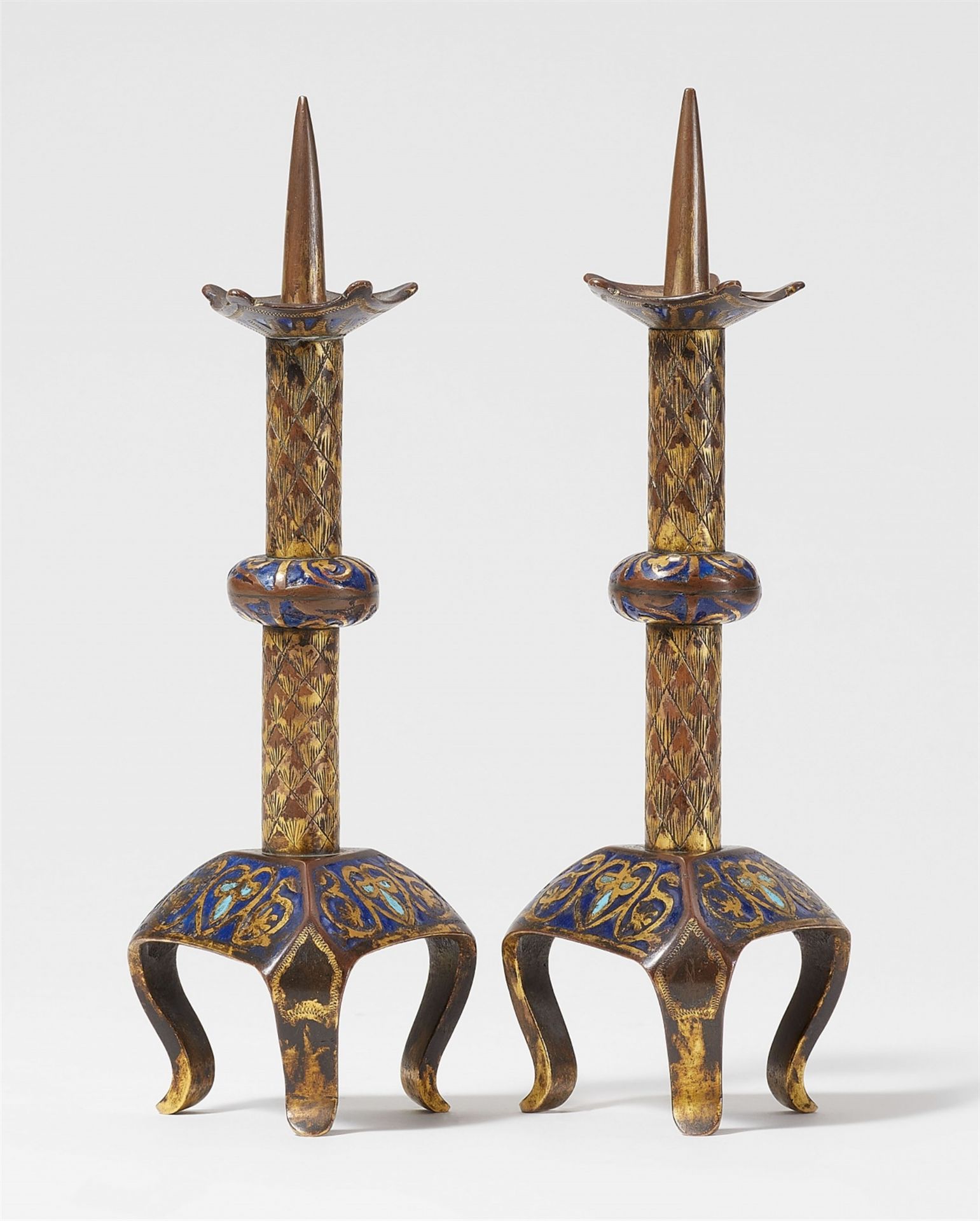 Two early 13th century Limoges enamel candlesticks