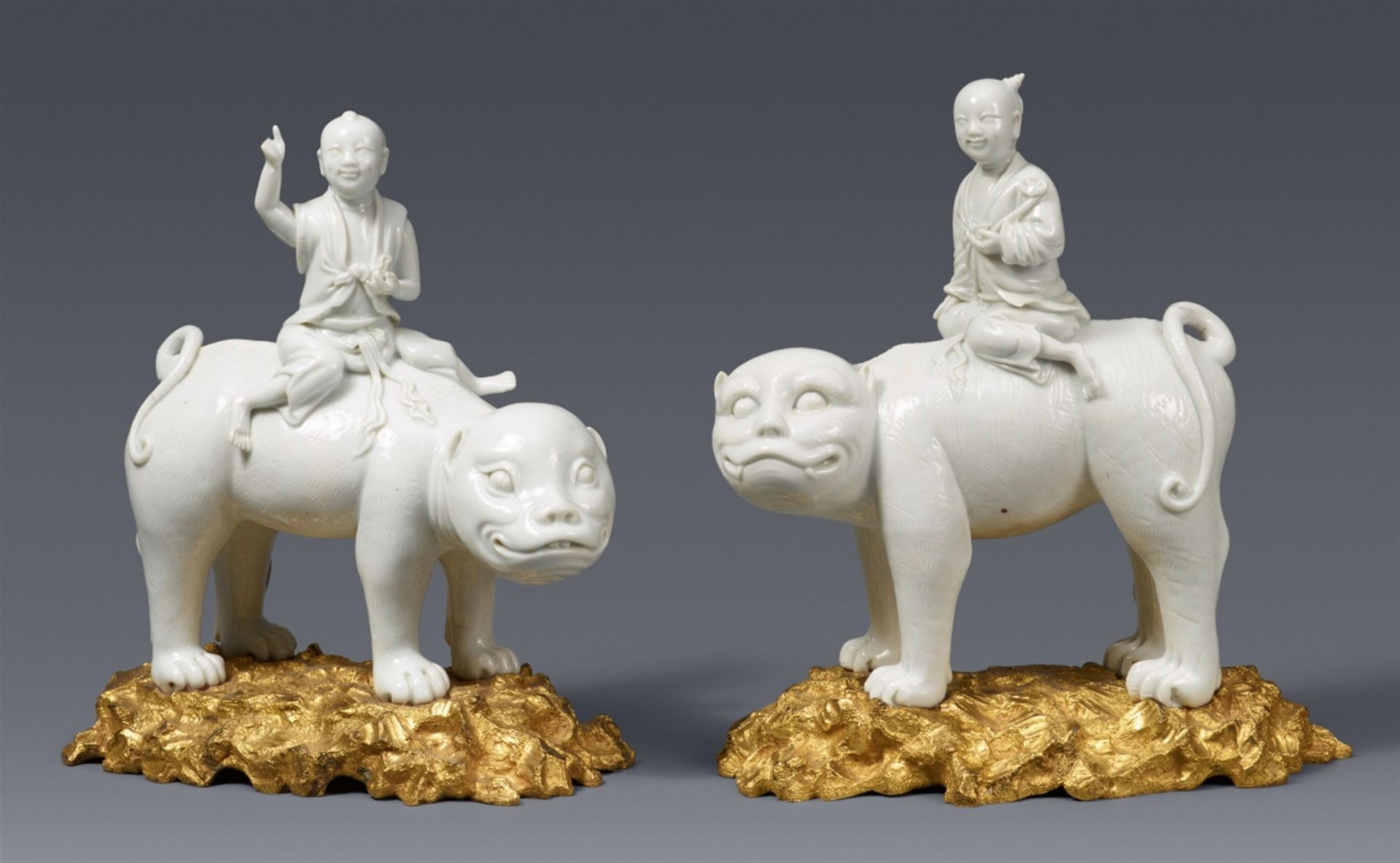 A pair of ormolu-mounted Dehua blanc de Chine figures of two boys on tigers. First half 18th century