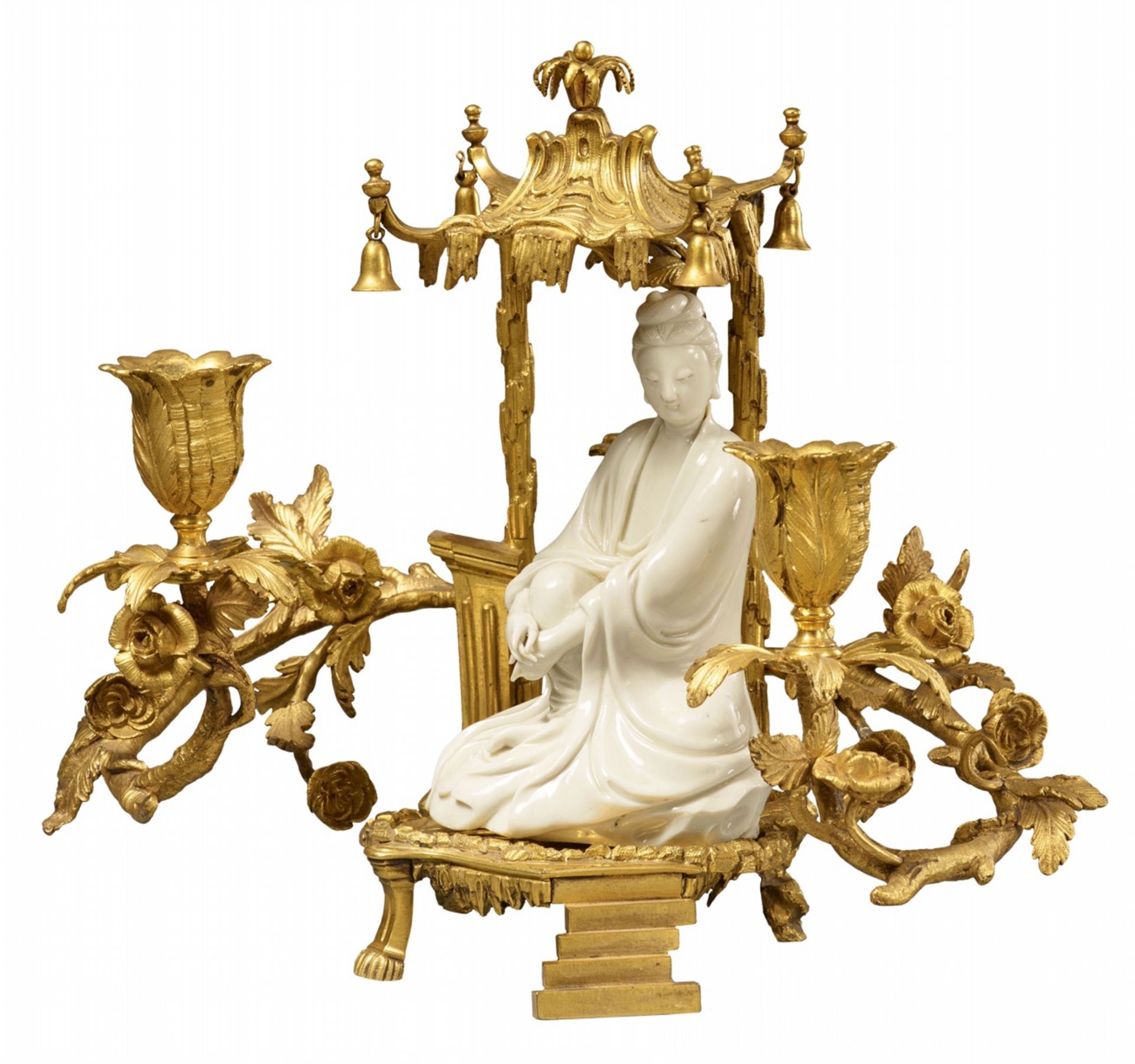 An ormolu candelabrum with a Dehua blanc de Chine figure of Guanyin. Kangxi Period (1662-1722)