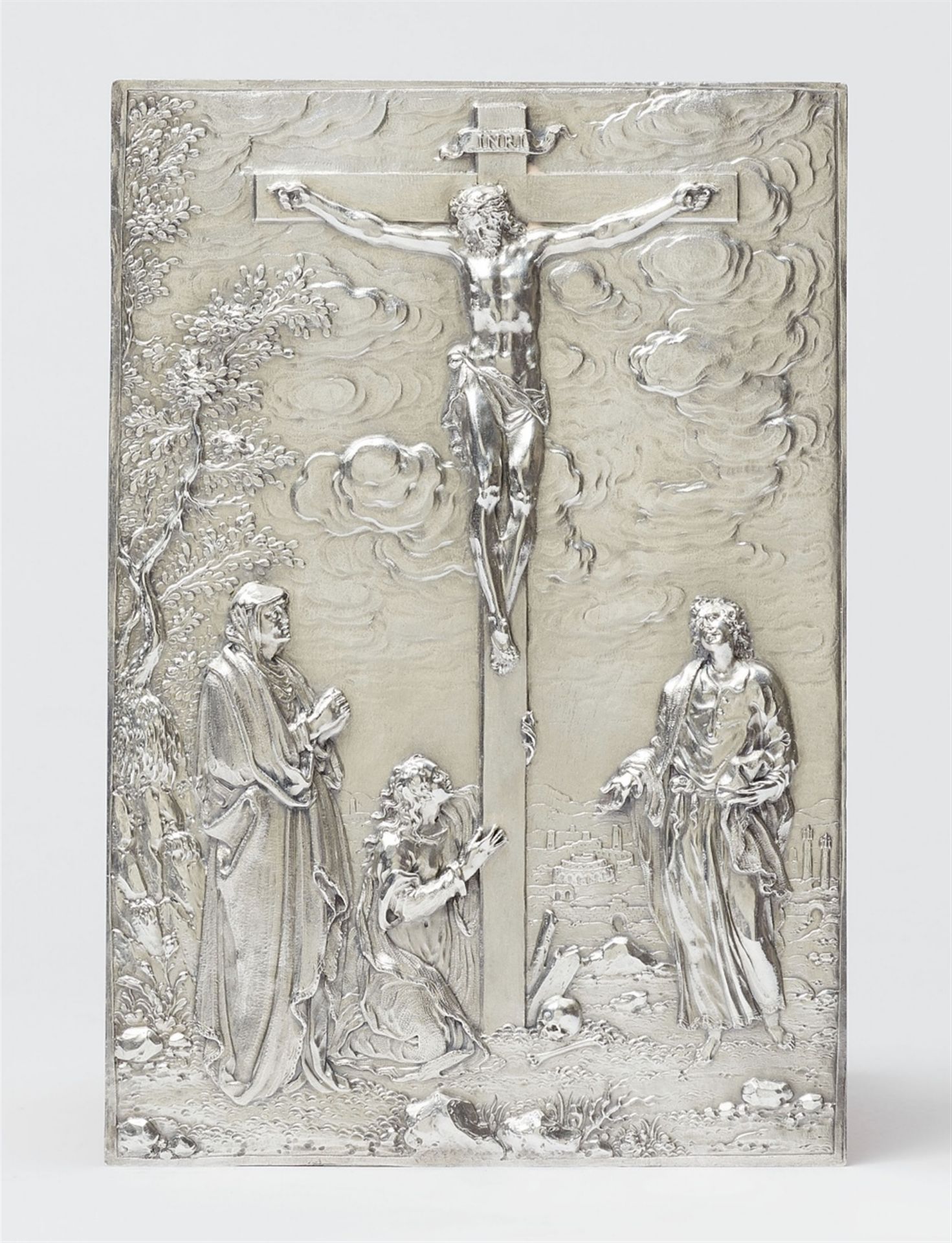 A silver plaque with the crucifixion