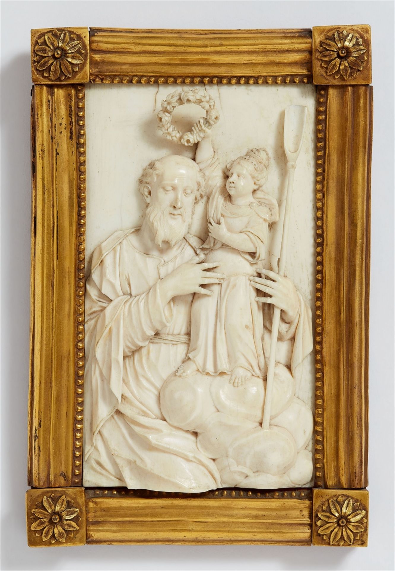 A late 17th century Dutch carved ivory figure of Saint Joachim crowned by the Virgin Mary