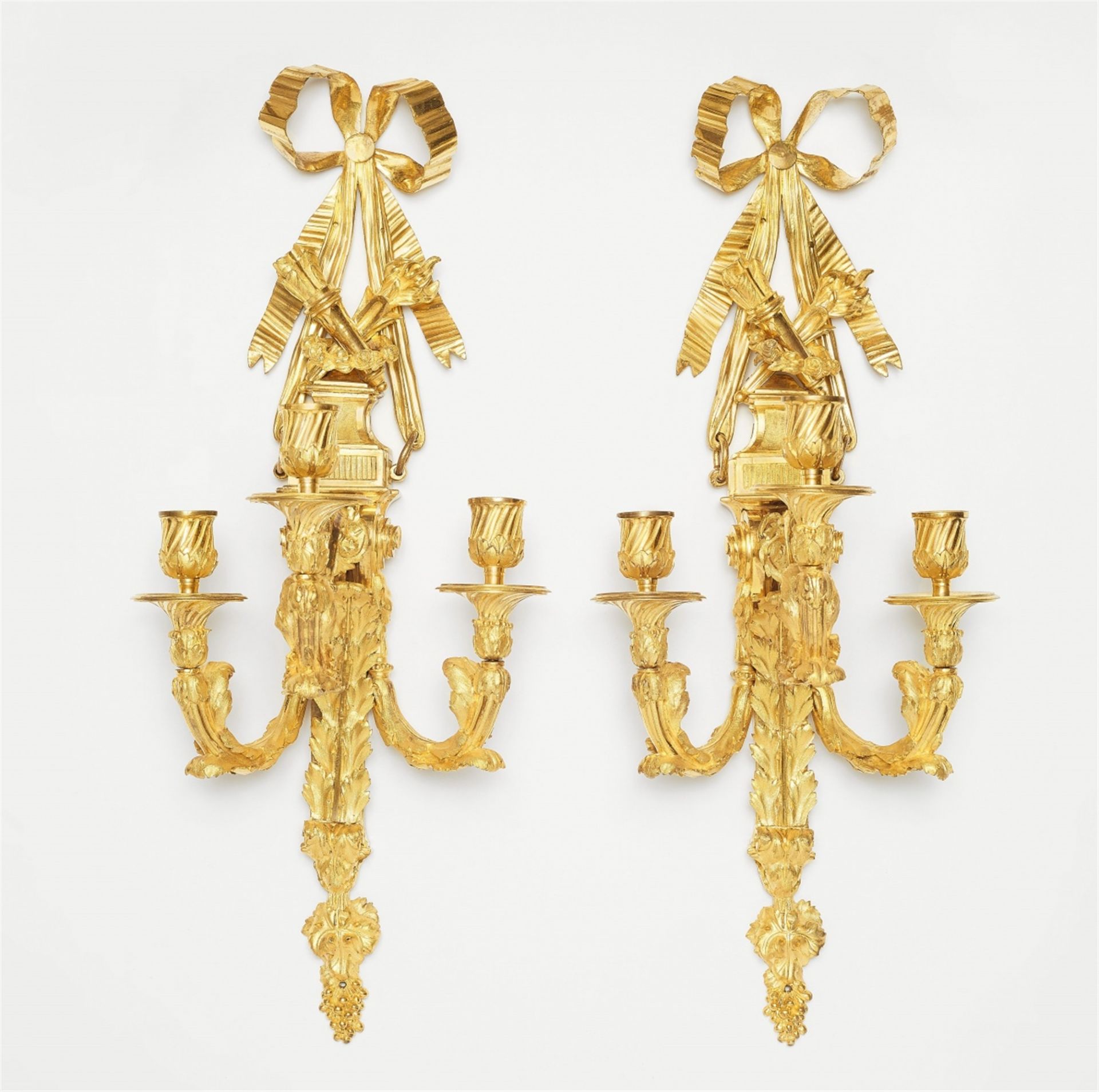 An exceptional pair of ormolu appliqués with a quiver and torch