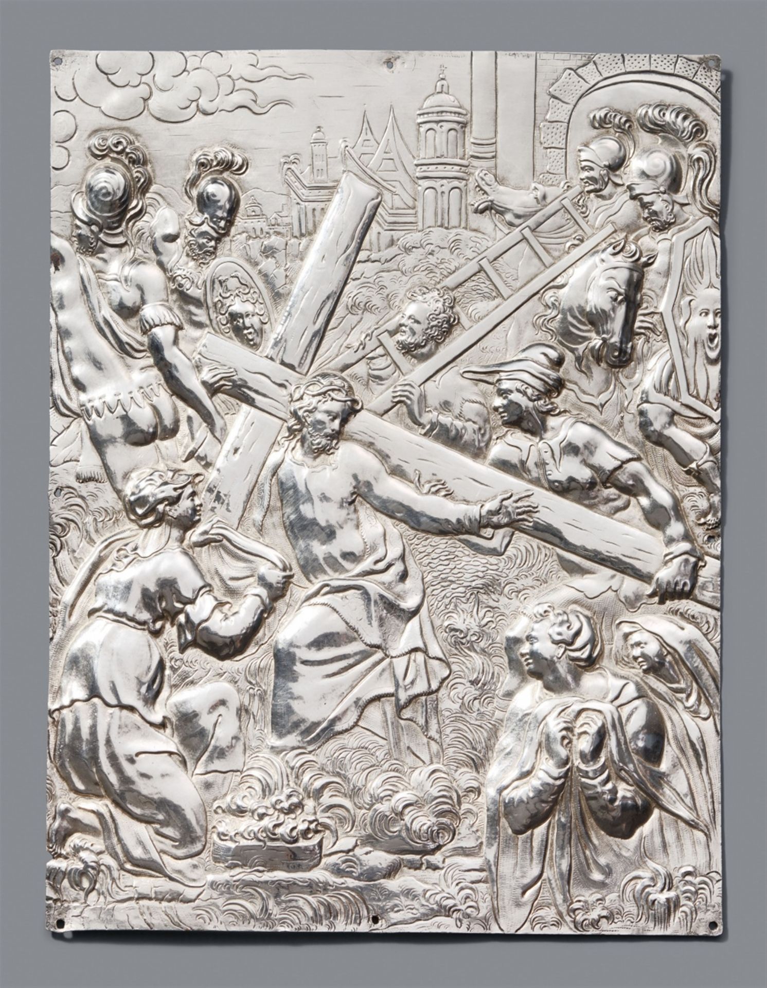 A silver plaque with Christ carrying the cross