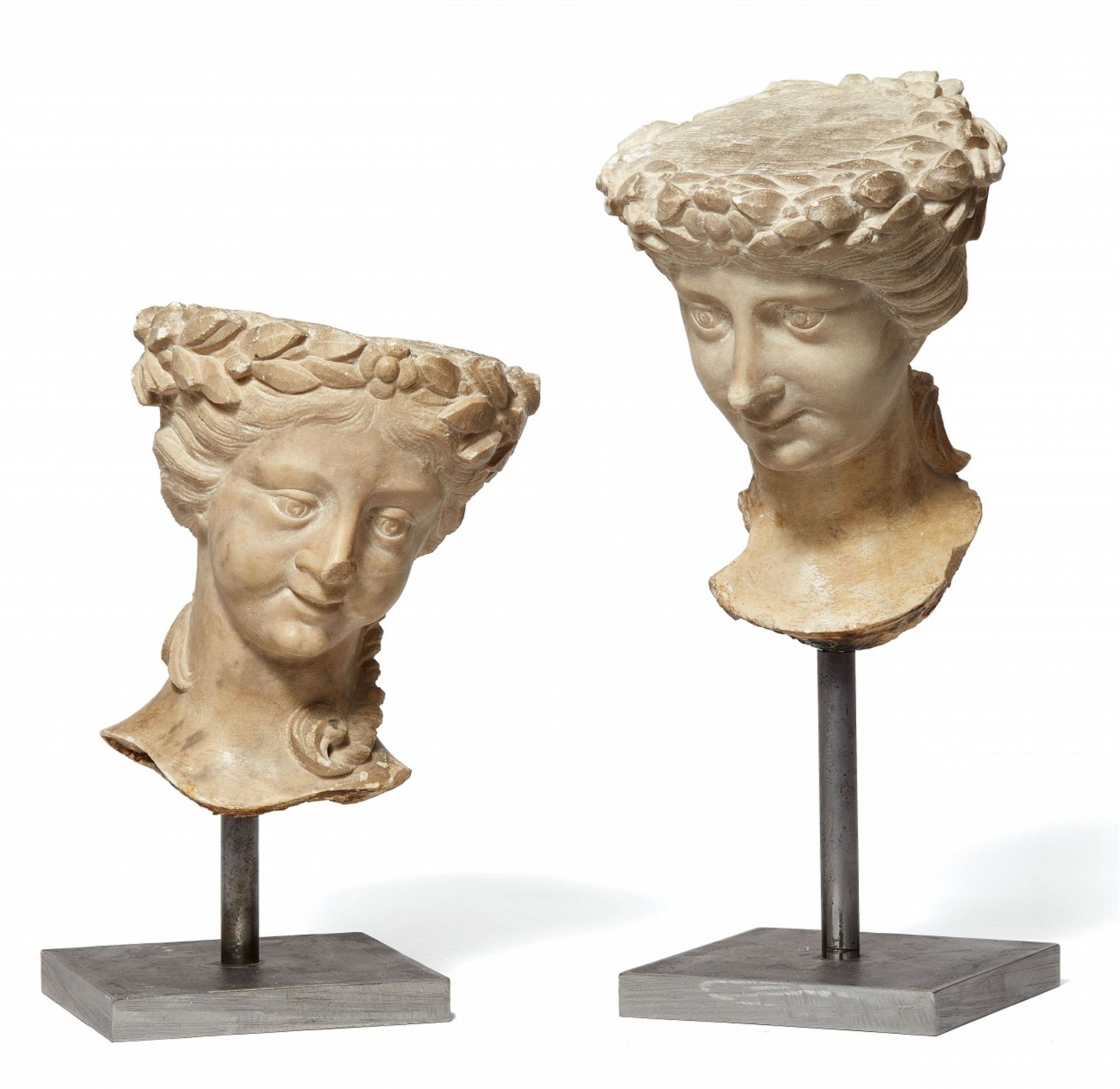 Two female heads carved from limestone