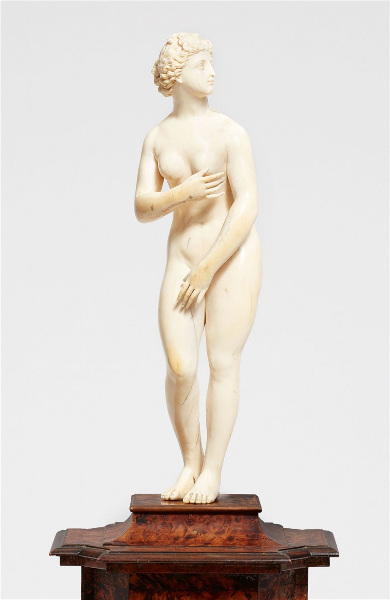 A carved ivory figure of the Venus Medici