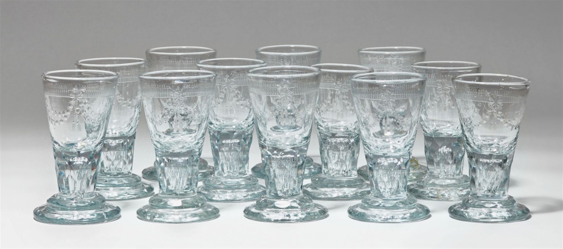 A set of 12 cut glass liqueur glasses