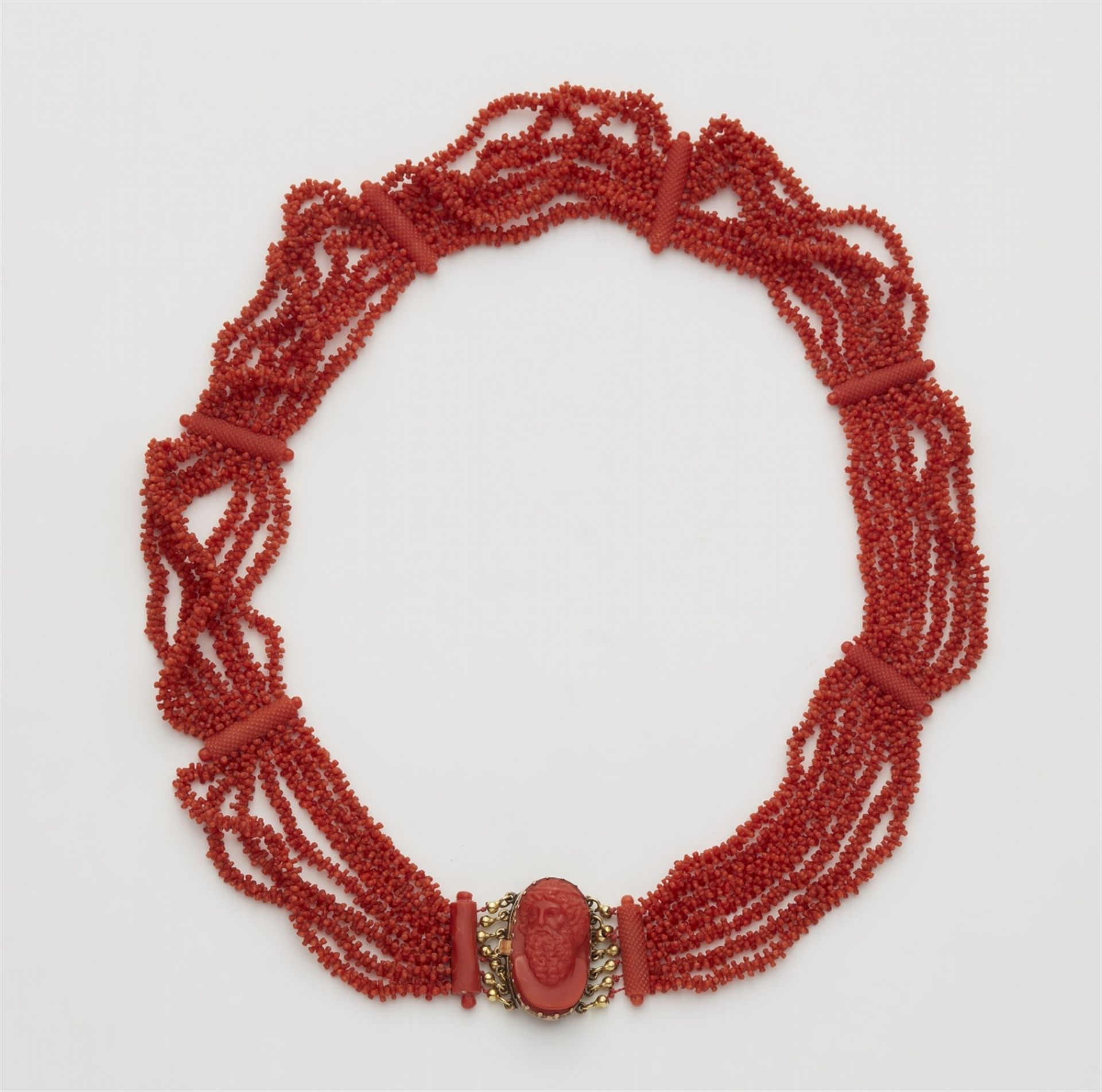 A 14k red gold coral necklace with a shell cameo clasp