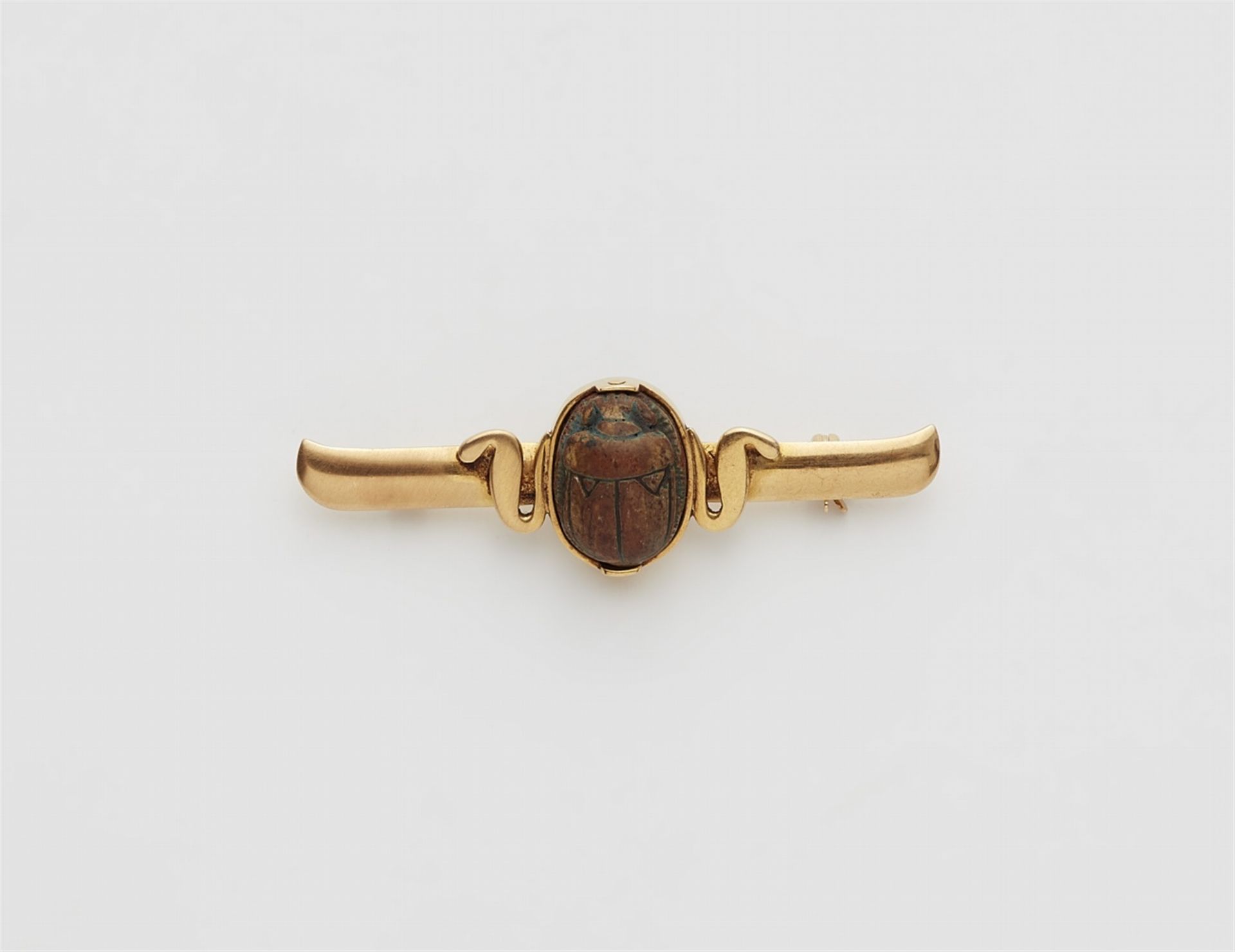 An 18k gold brooch with an Egyptian scarab amulet