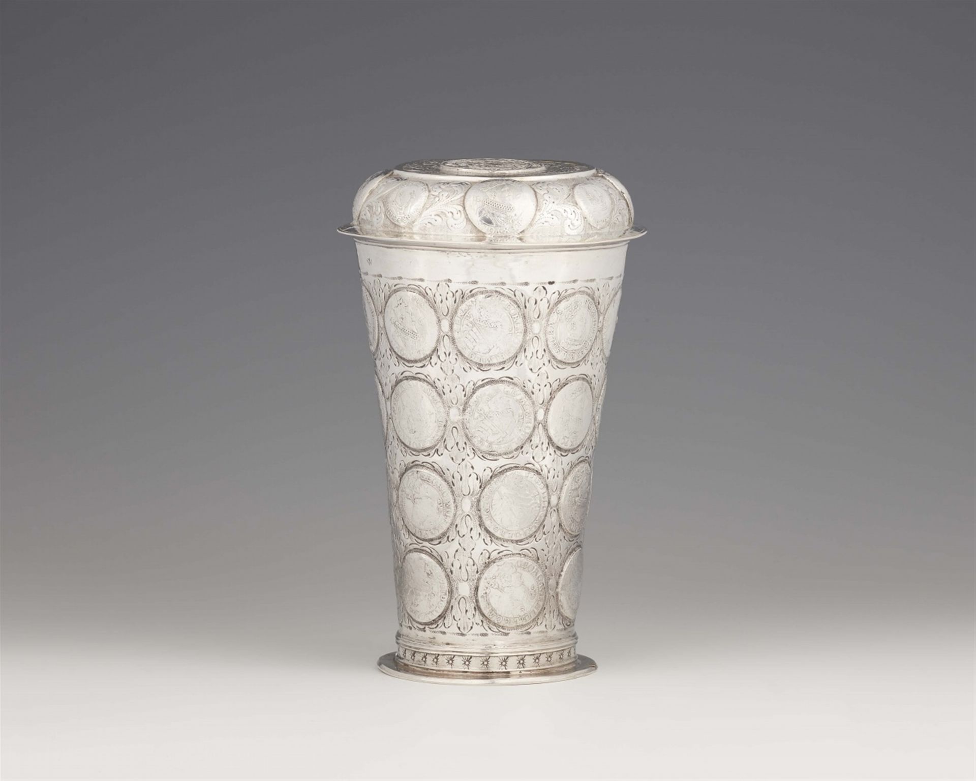 A large Thorn coin set beaker and cover