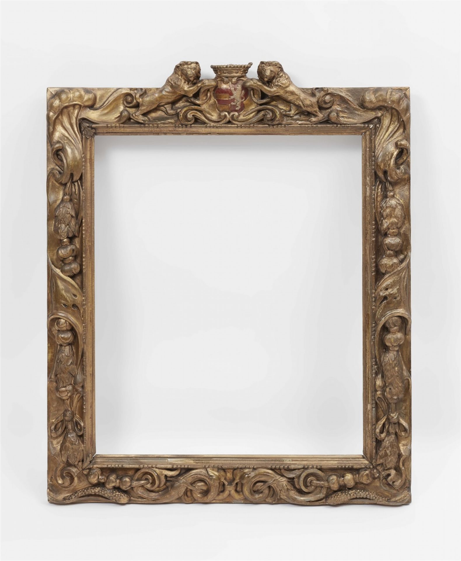 A carved Flemish frame with coat of arms