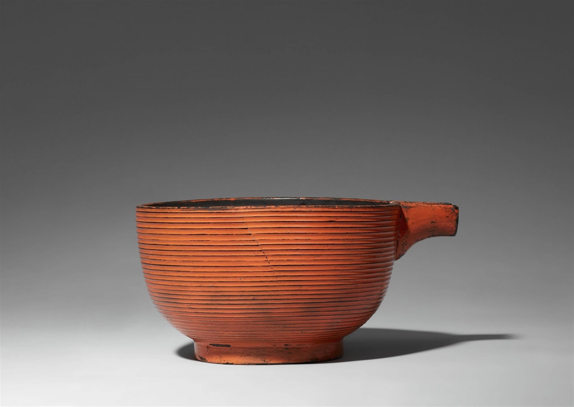 A large negoro-type bowl with a spout. Edo period