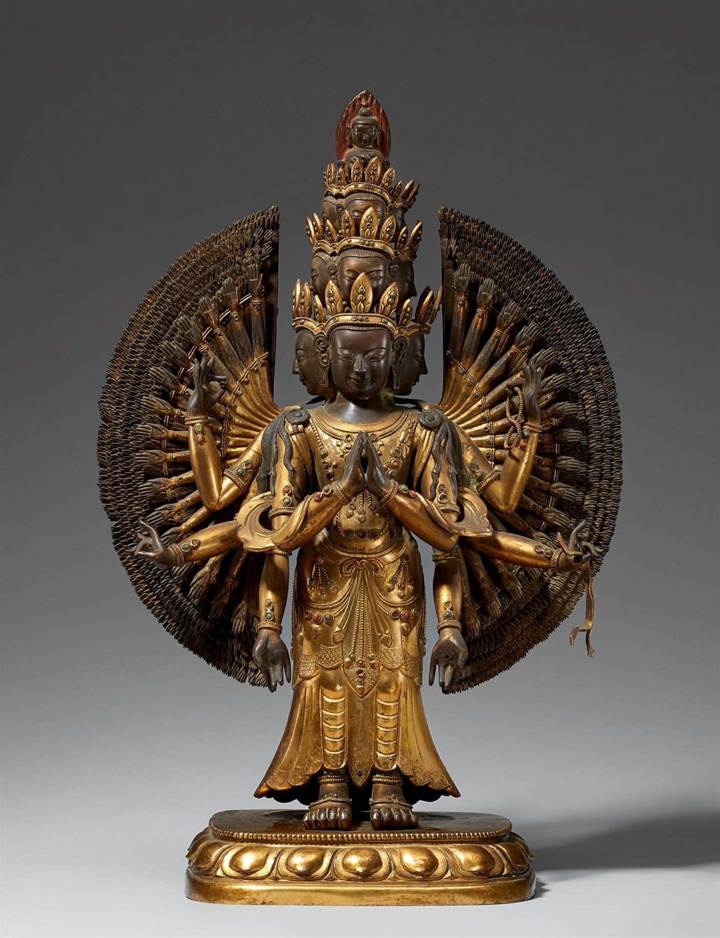 A large and exquisite casted gilt bronze figure of Avalokiteshvara Ekadashamukha. Tibetochinese. 18t