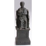 Dark bronze figurine depicting Saint Peter sitting on the Roman throne.
