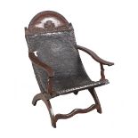 Cedarwood and embossed leather armchair. Colonial School. Mexico. Circa 1800.