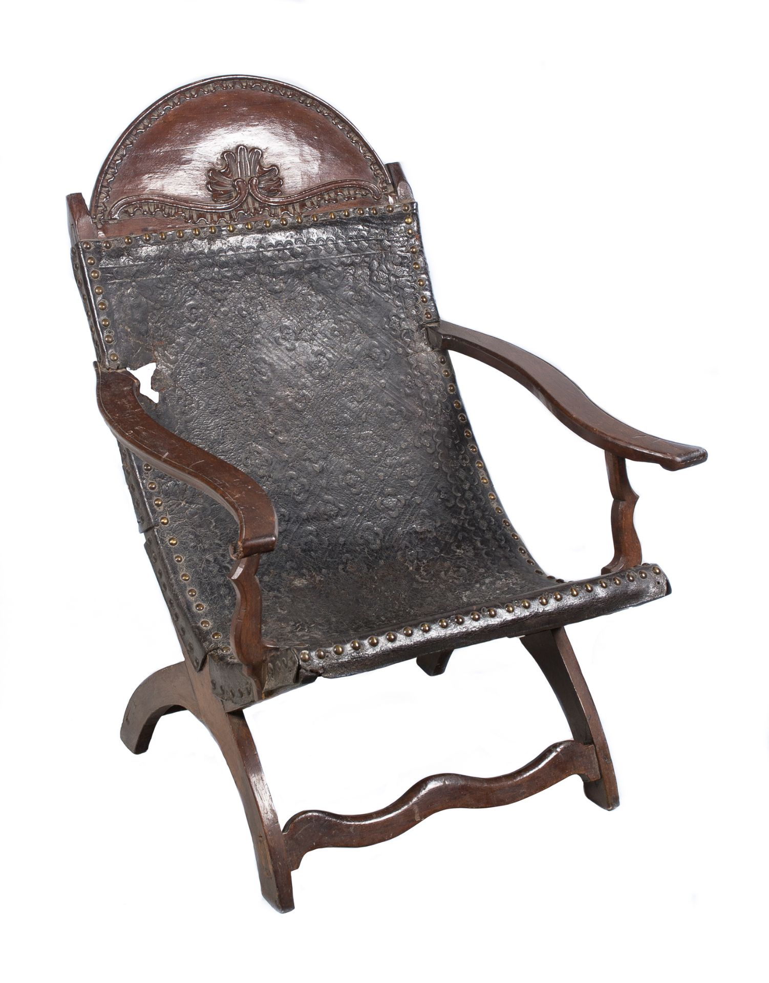 Cedarwood and embossed leather armchair. Colonial School. Mexico. Circa 1800.