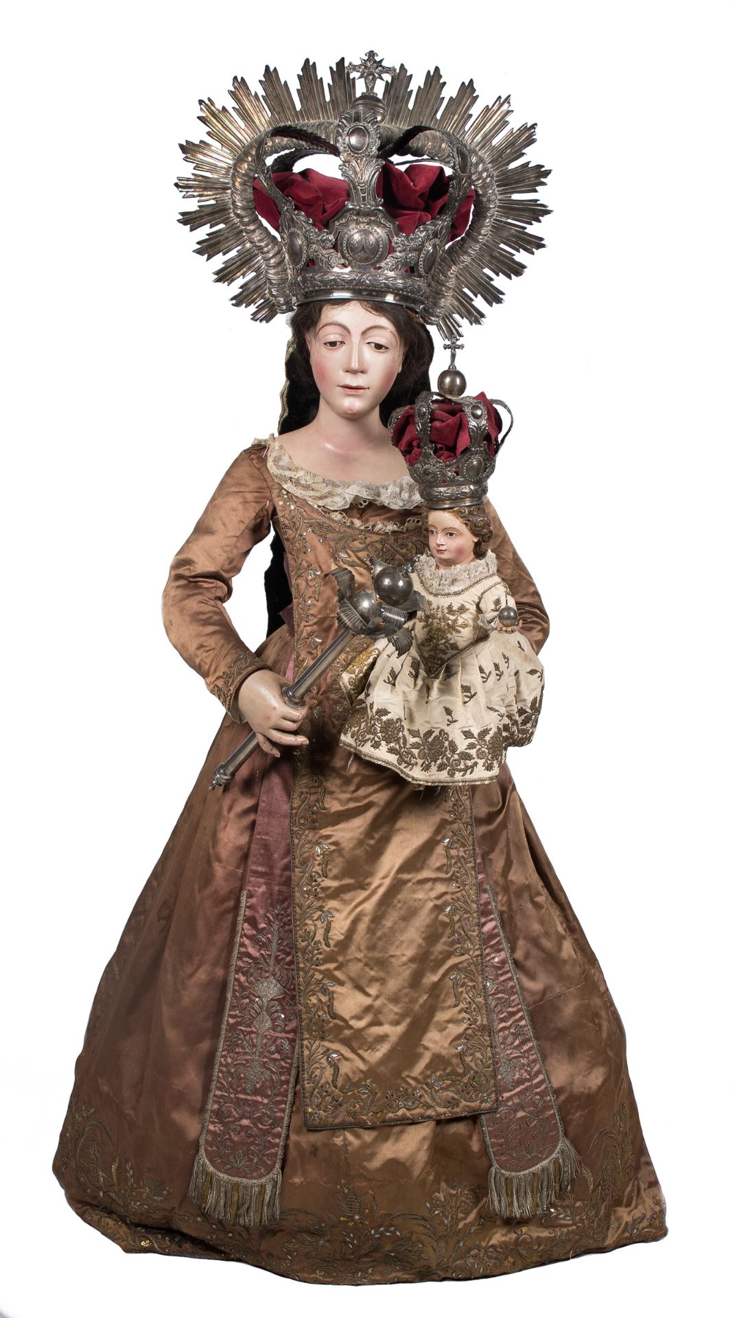 "Madonna and Child". Carved and polychromed wooden sculpture, with silver crowns and staff. Coloni