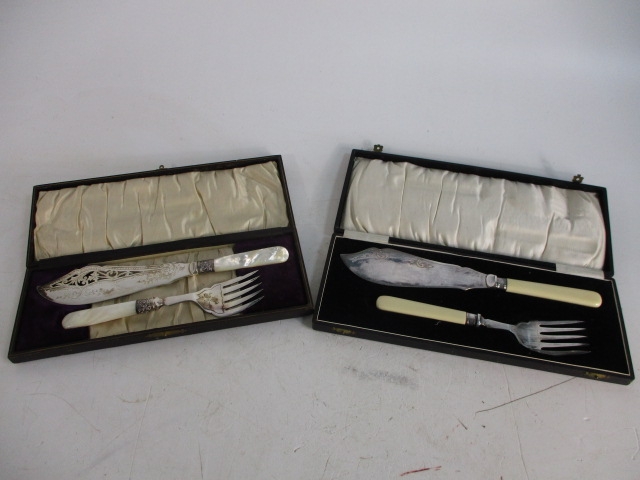 Pair of vintage cased fish server sets, one has mother of pearl handles.