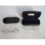 Two pairs of gold coloured metal spectacles