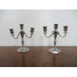 Modern silver coloured pair of candelabras. H21 x W18cms