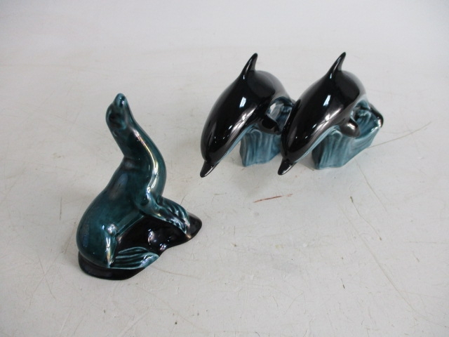 Trio of Poole pottery, to include seal and pair of dolphins.