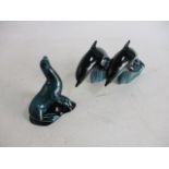 Trio of Poole pottery, to include seal and pair of dolphins.