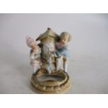 Antique porcelain figurine depicting boy/girl at well, possibly Dresden.