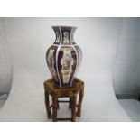 Oriental style vase on bamboo plant stand