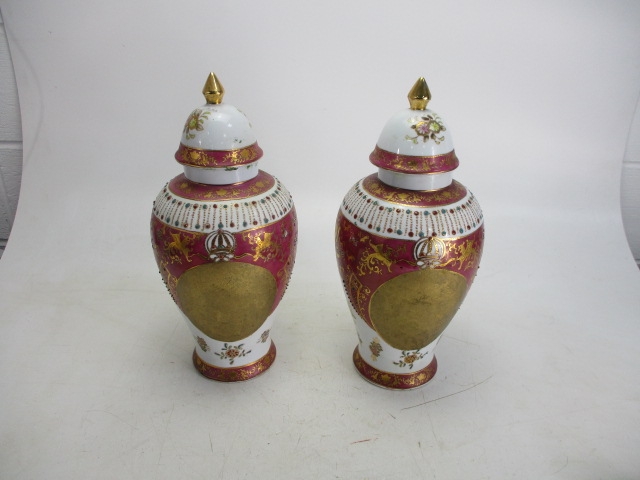 Large pair of decorative Gold/pink detailed lidded urns/vases.