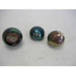 Trio of paperweights to include iridescent and Okra glass signed Richard Golding.