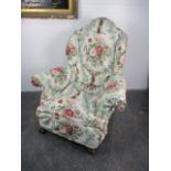 Early 20th century armchair with claw feet and throw over cover.