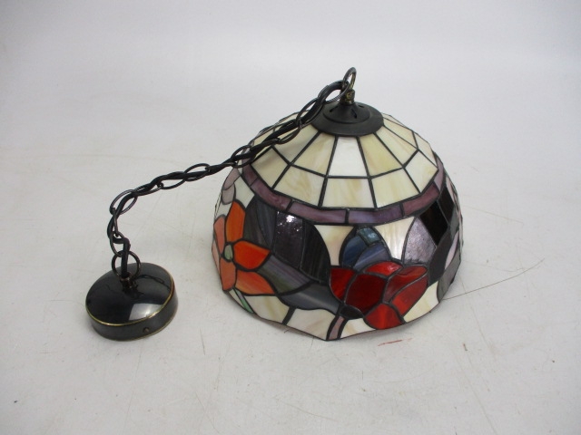 Tiffany style stained glass detail lamp shade with ceiling light fitting.
