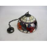Tiffany style stained glass detail lamp shade with ceiling light fitting.