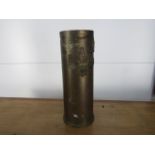 Large vintage trench art shell with applied cap badges 33cm high