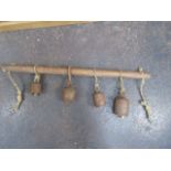 Collection of 4 vintage cow bells on a wooden harness