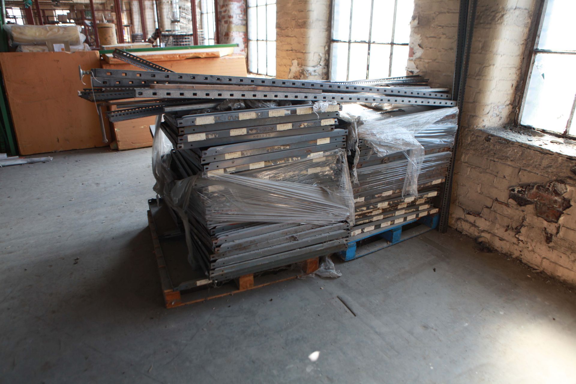 Pallet of stores shelving uprights and shelves