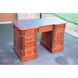 20th century knee hole desk with draws and a cupboard with a leather inset