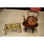 A mixed collection of items to include: copper tea pot, brass lion trivet and a wooden Childs