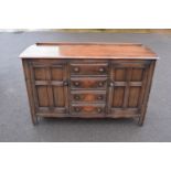 Ercol dark elm sideboard with 2 doors and 4 drawers. In good functional condition with some areas of