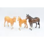 Beswick palomino mare facing right 1991, palomino thoroughbred foal 1813 and a brown horse facing