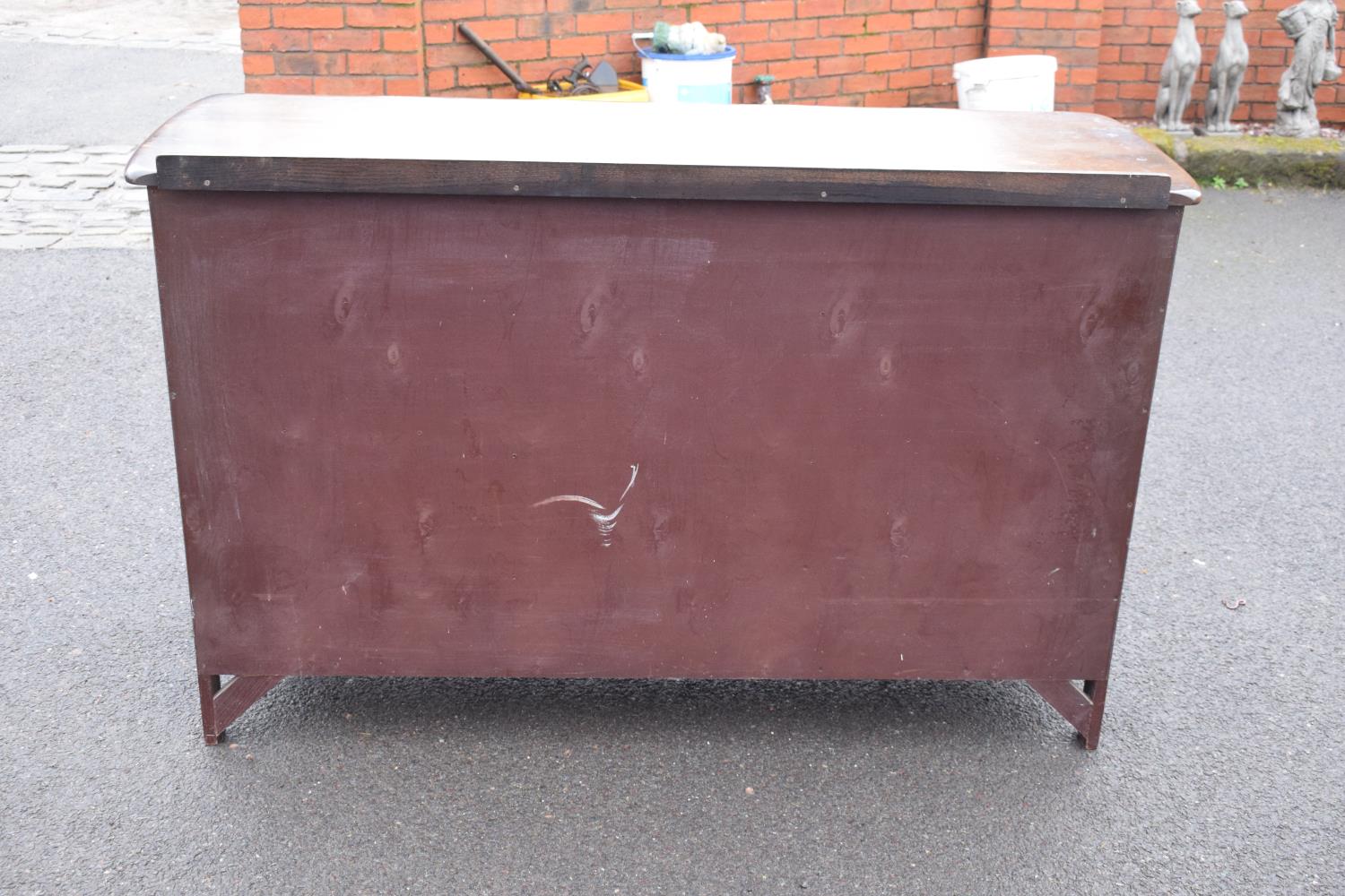 Ercol dark elm sideboard with 2 doors and 4 drawers. In good functional condition with some areas of - Image 7 of 9