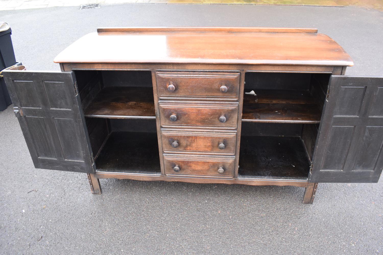 Ercol dark elm sideboard with 2 doors and 4 drawers. In good functional condition with some areas of - Image 9 of 9