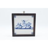 19th century framed blue and white Delft tile. There is some crazing and also some surface damage.