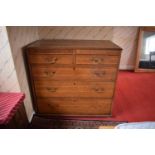 Edwardian oak chest of drawers on caster wheels. There some splits to the wood and sections of