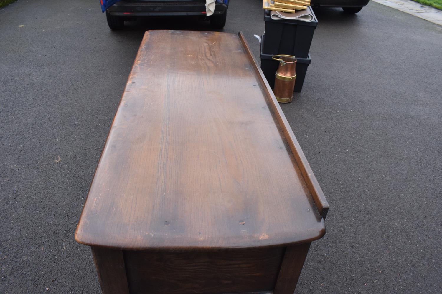 Ercol dark elm sideboard with 2 doors and 4 drawers. In good functional condition with some areas of - Image 6 of 9