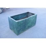 Early 20th studded metal water trough which has been previously used as a planter. There have been