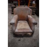 Early 20th century French tan leather armchairs. Both in a poor state of condition with both in need