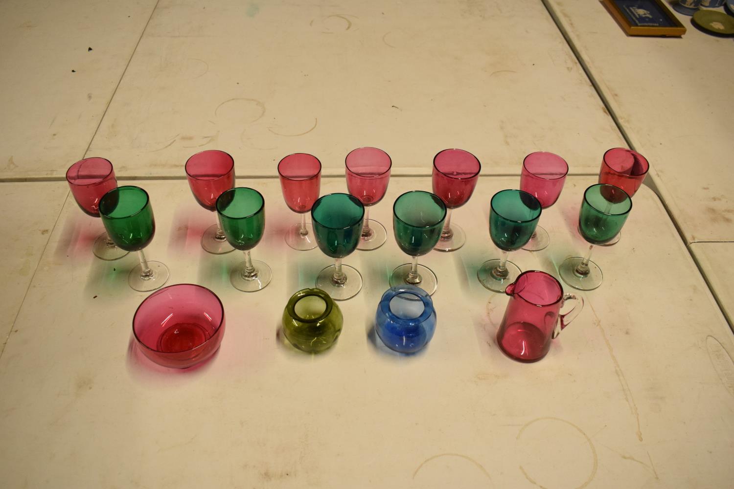 A collection of various coloured 20th glass to include wine glasses of different sizes, bowls etc (
