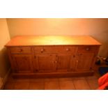 20th century pine sideboard with 3 draws and 4 doors. Signs of wear and tear and use in a family