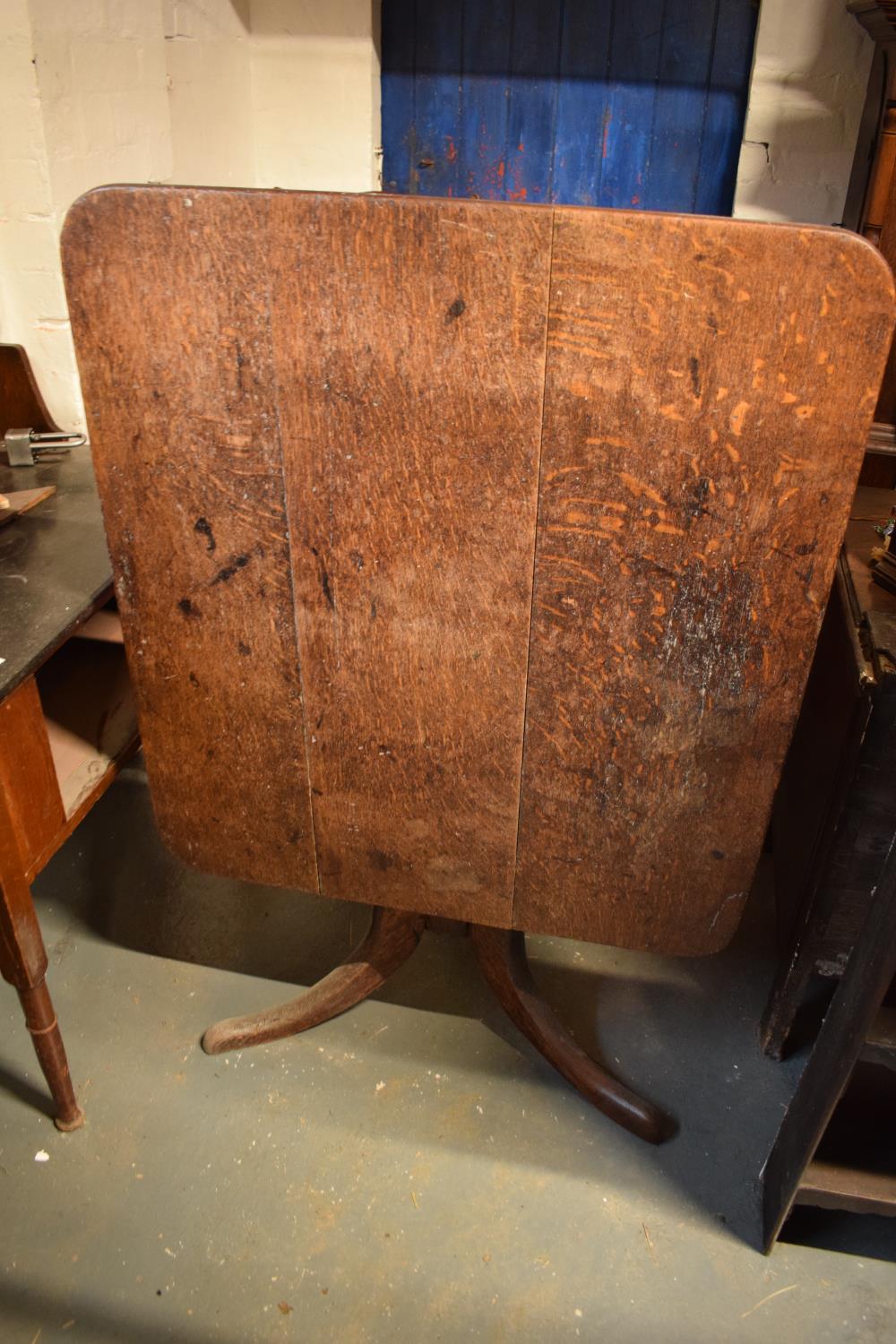 Victorian oak square tilt top table. In need of attention as it got damp and started to go moody